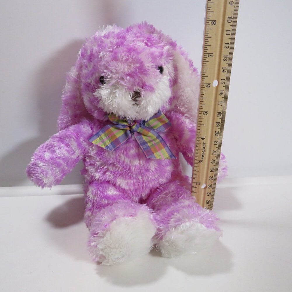 Purple spotted plush rabbit with long floppy ears and a plaid bow